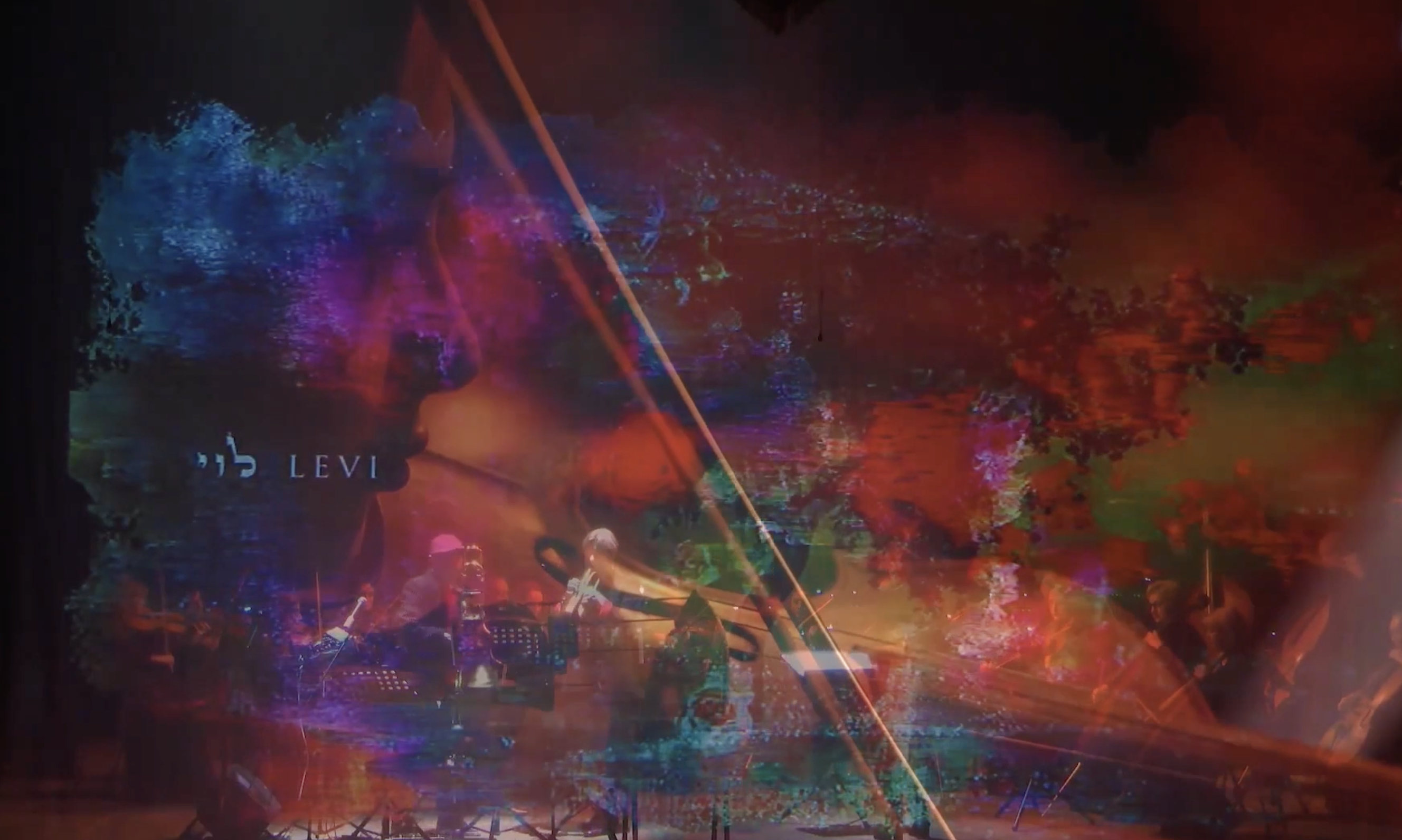 Abstract colour projection overlaid with live video of the orchestra.