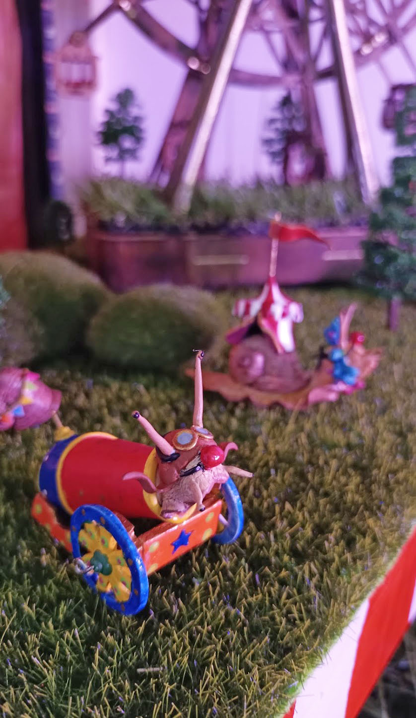 Colourful hand-made circus figureheads staged on the grass