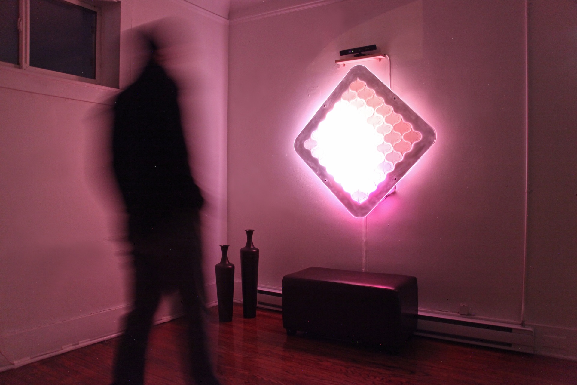 Light Mirror in a darkened room, glowing pink